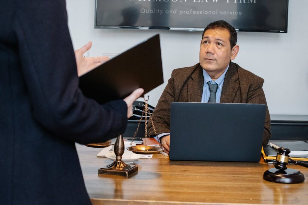 Serious ethnic lawyer discussing new case with colleague