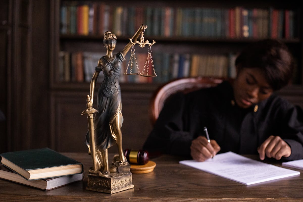 A Figurine of the Lady Justice on the Table of a Judge