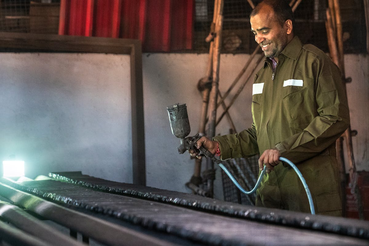 Blue Collar Worker with Paint Spray Gun