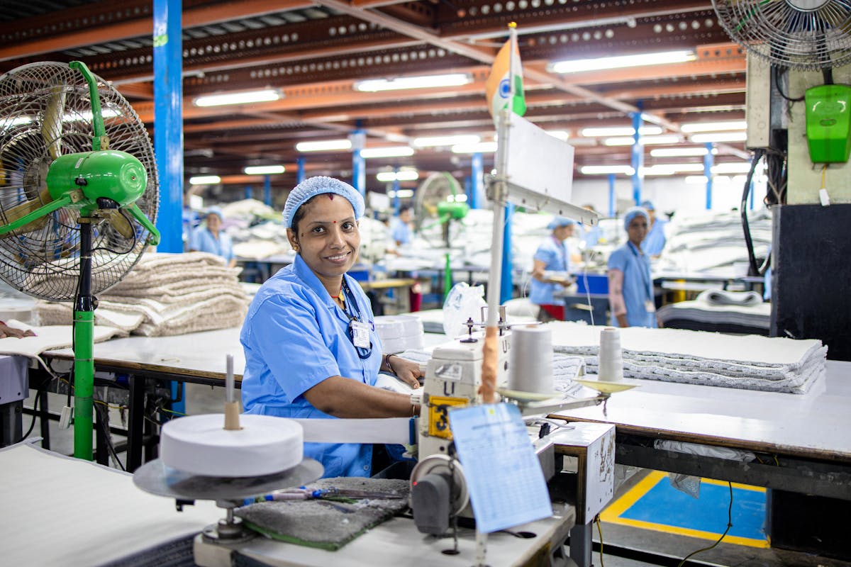 Indian Factory Worker Operating Sewing Machine