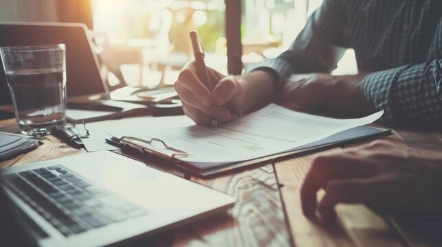 A person reviewing legal documents for estate planning with a financial advisor.