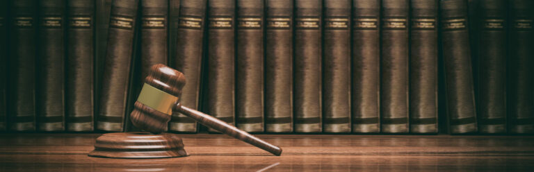 Law theme. Wooden gavel and books. 3d illustration