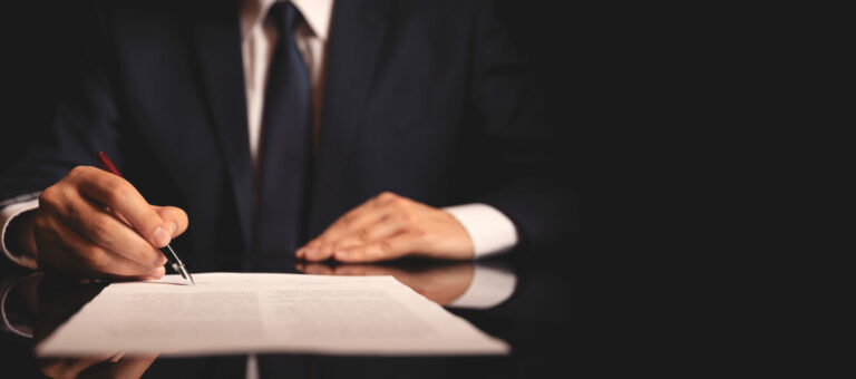 Close up lawyer working in the office signing agreement